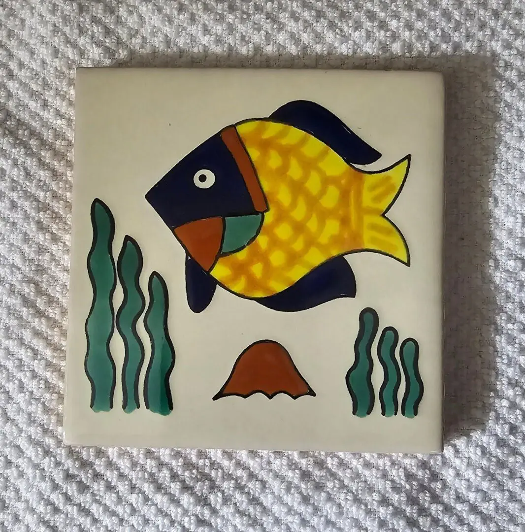 Colorful fish on decorative ceramic tile.