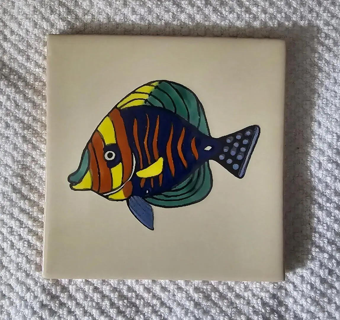 Colorful fish painted on ceramic tile.
