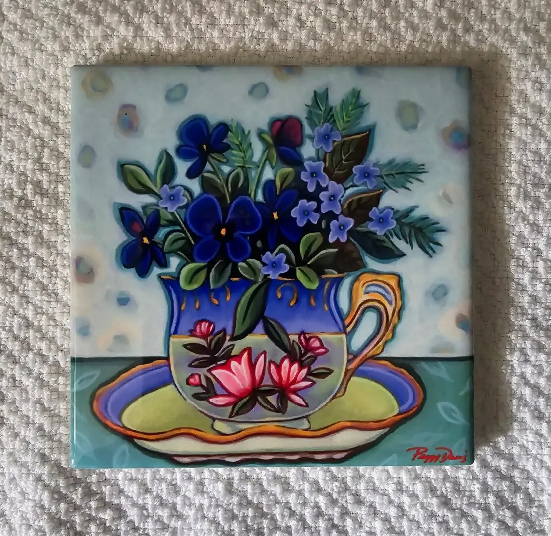 Painting of flowers in a decorative cup.