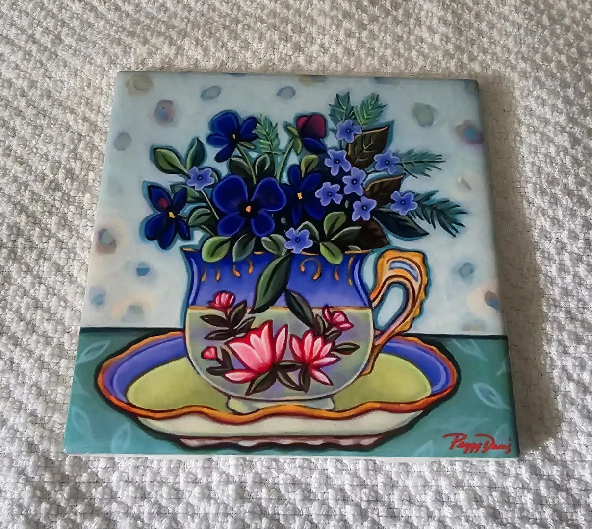Colorful flowers in decorative teacup painting.