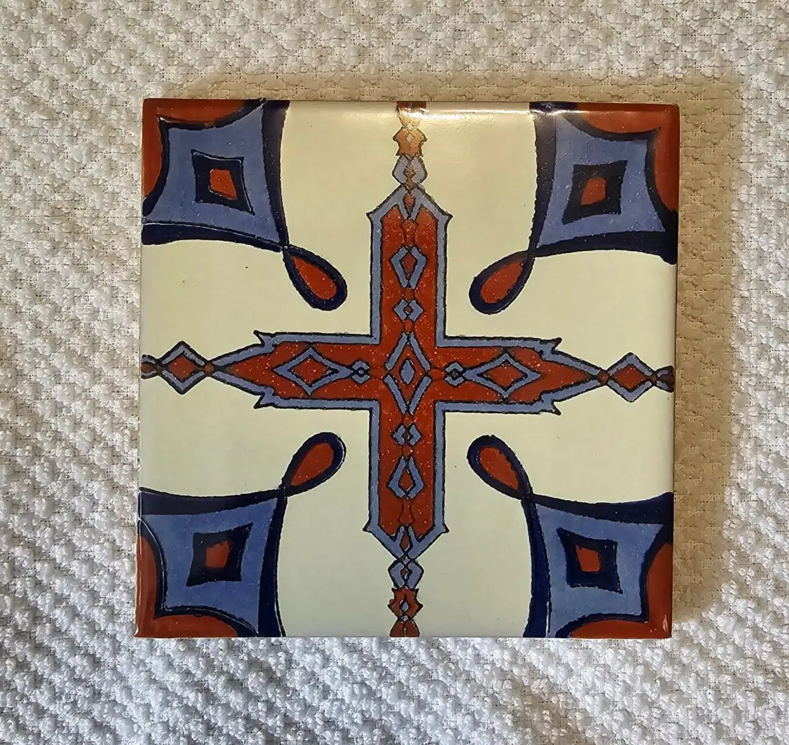 Square ceramic tile with red-blue cross motif