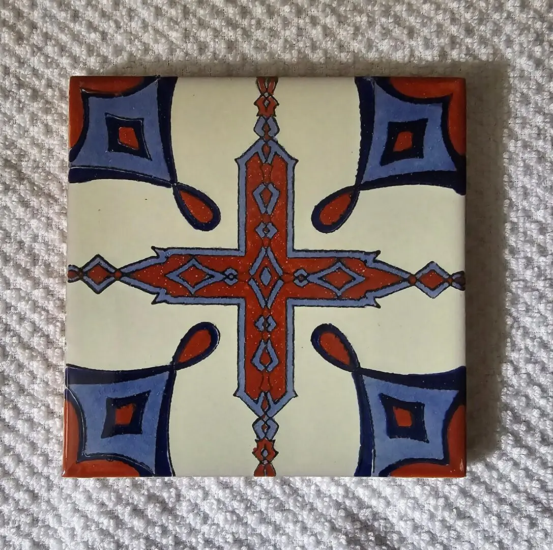 Decorative ceramic tile with geometric pattern.