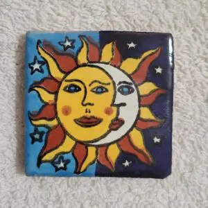 Colorful sun and moon tile art with stars.