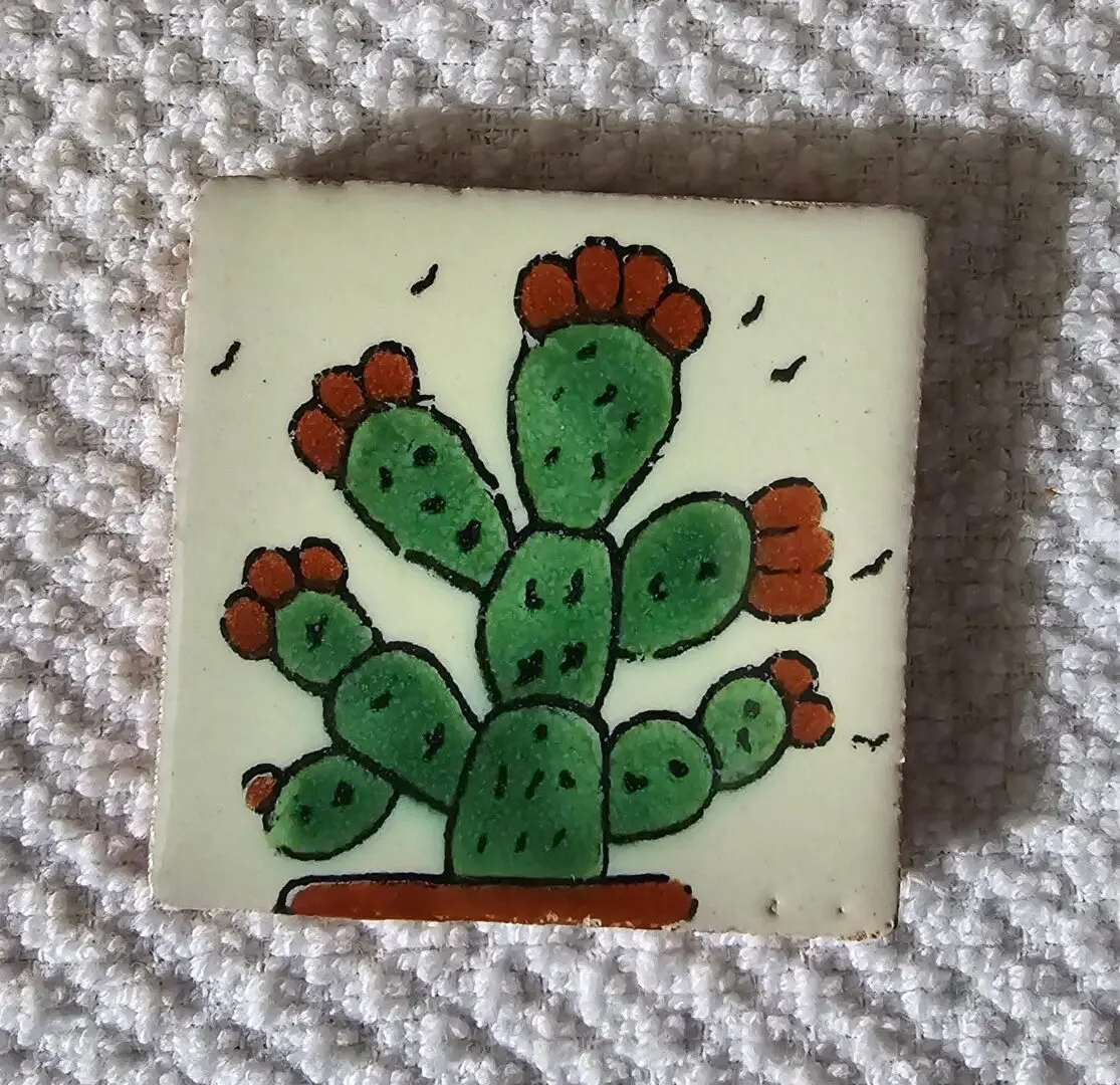 Hand-painted cactus tile with orange flowers