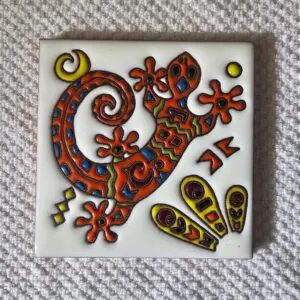 Colorful ceramic tile with abstract floral and geometric designs.