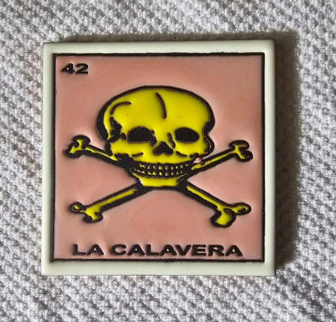 Yellow skull on a tile background.