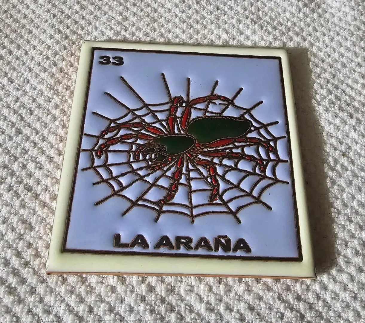 Spider on web with "La AraƱa" text.