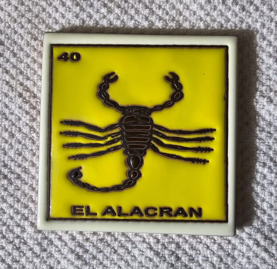 Yellow tile with scorpion design, "El Alacran".