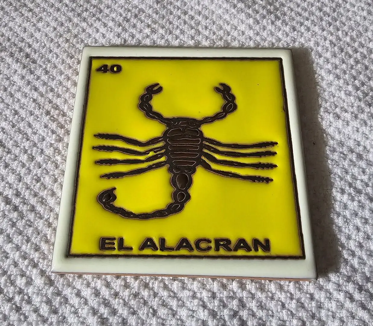 Yellow card with scorpion illustration and text.