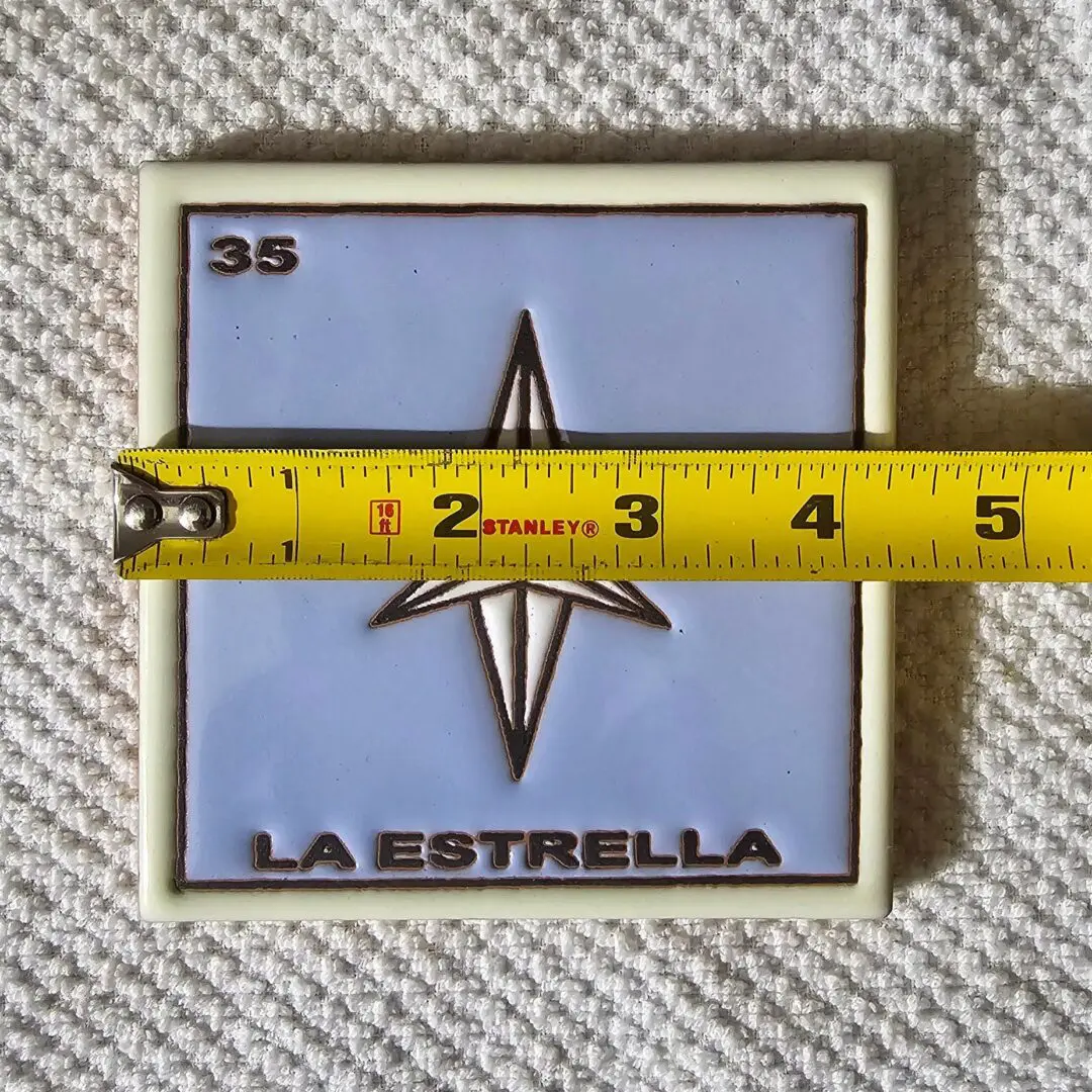 Tile with star design, measuring tape above.