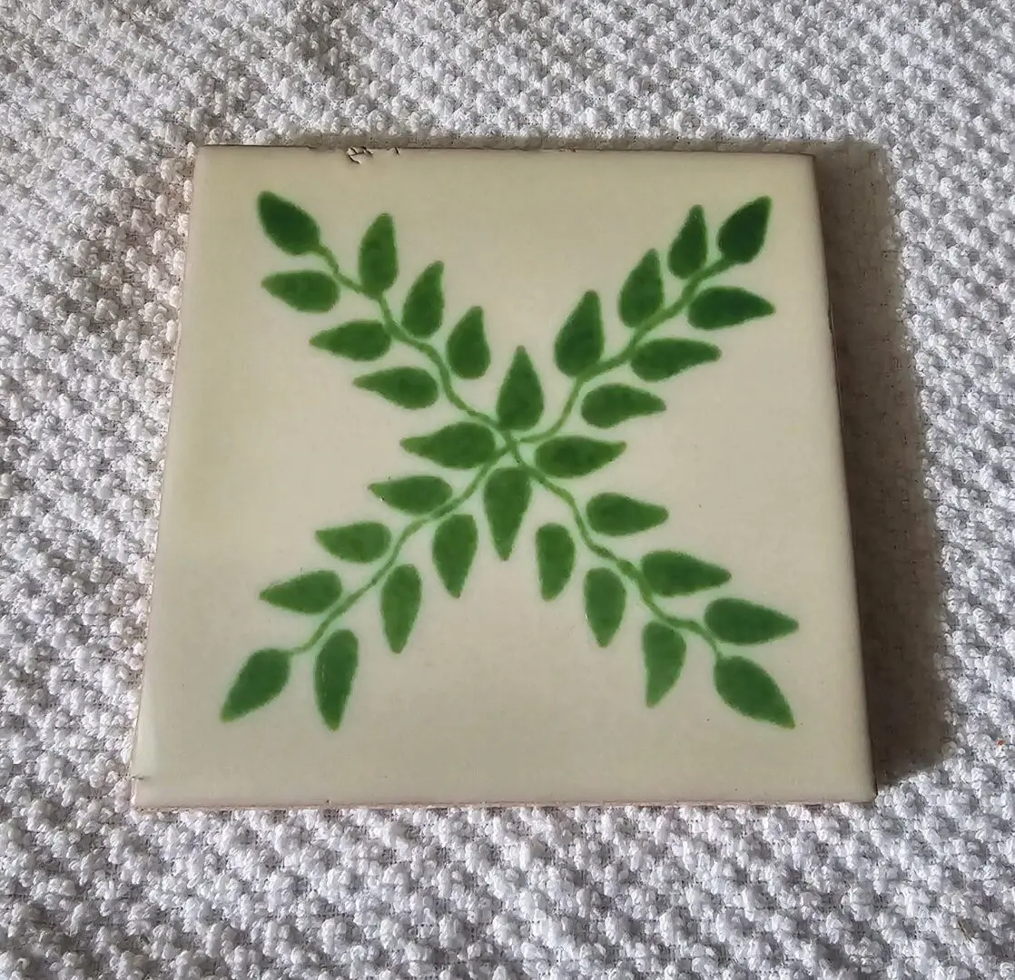 Tile with green leaf pattern on cloth.
