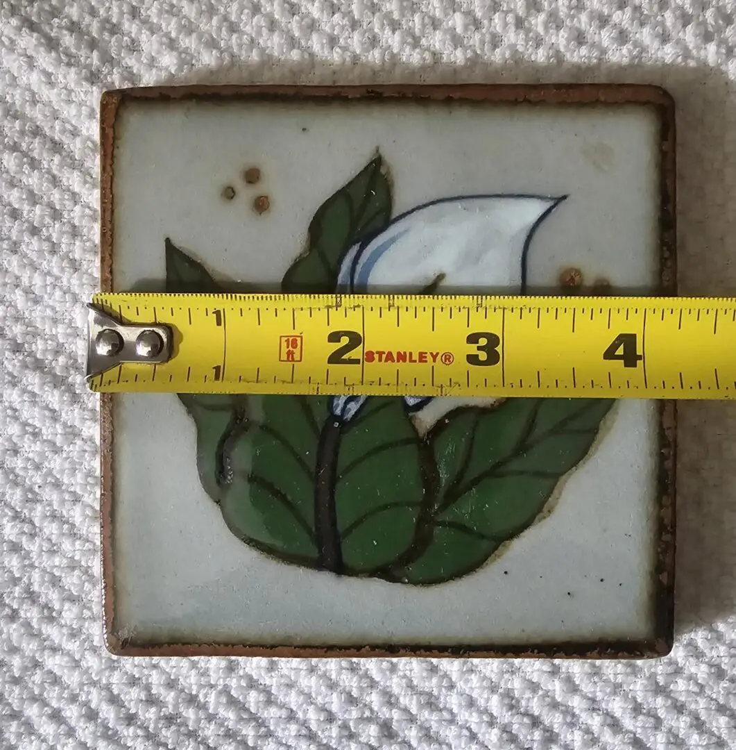White flower ceramic tile with tape measure