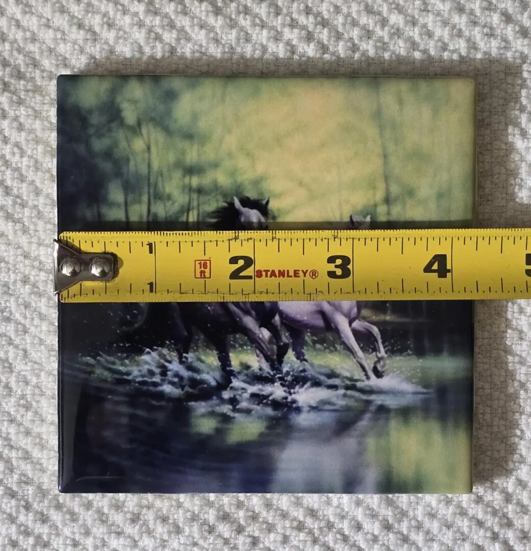 Tile with horses and measuring tape.