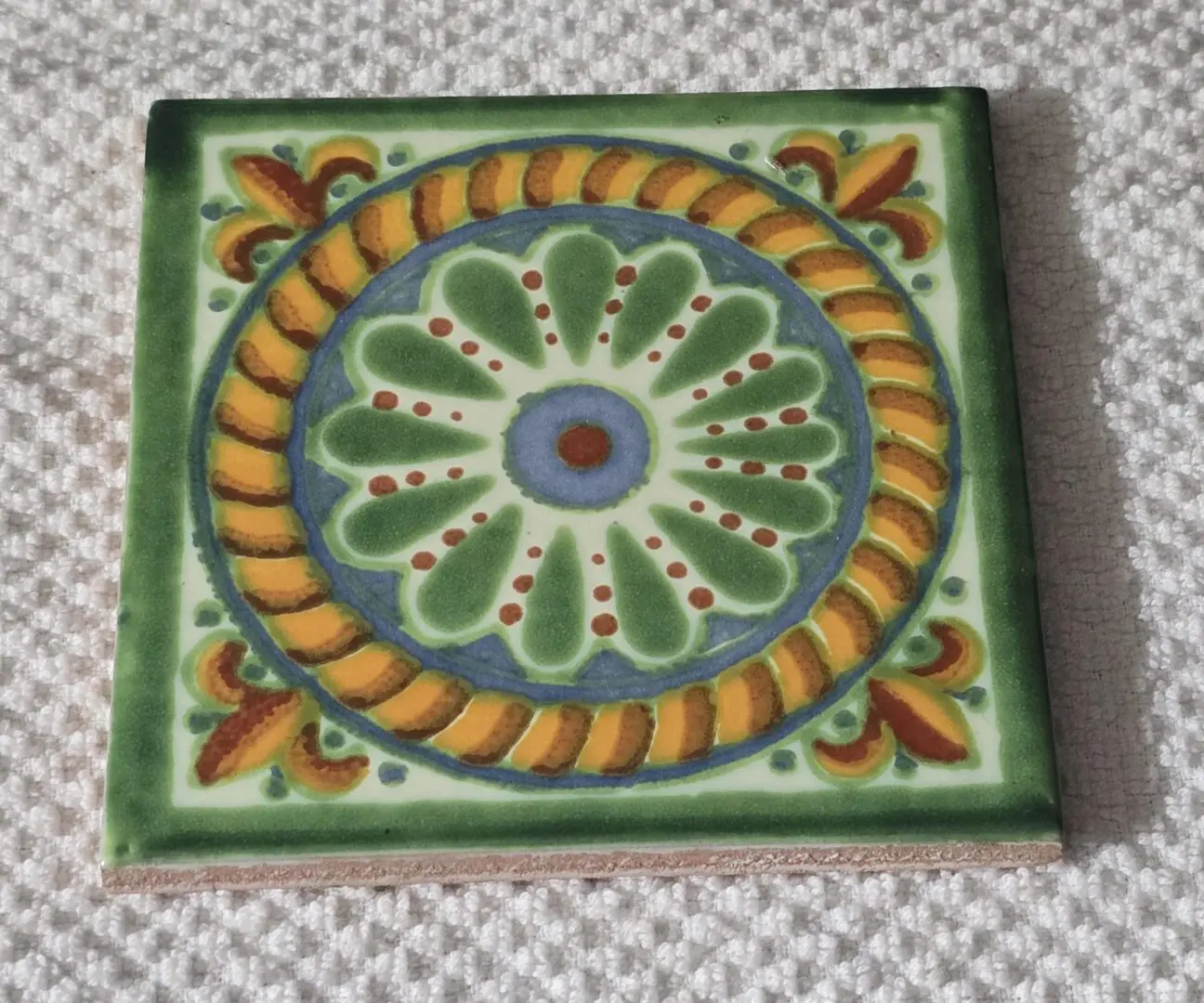 Hand-painted ceramic tile with floral medallion