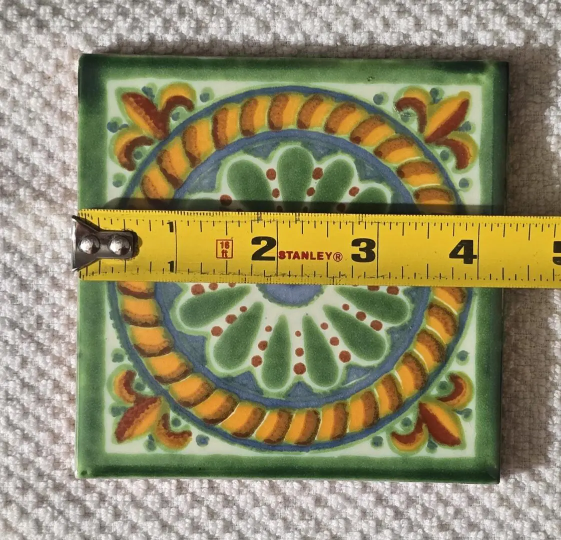 Colorful decorative ceramic tile with tape measure