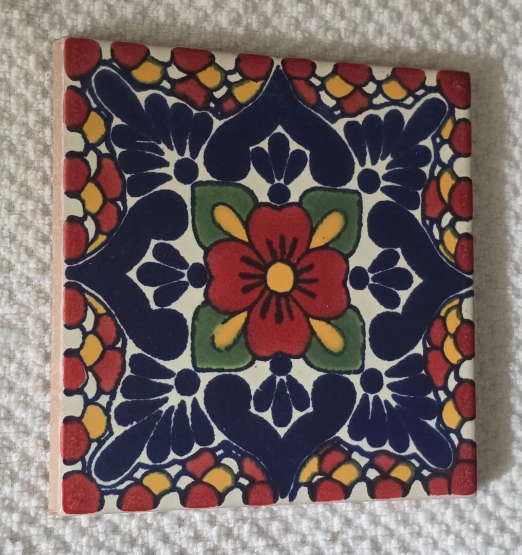 Hand-painted Talavera tile with red flower