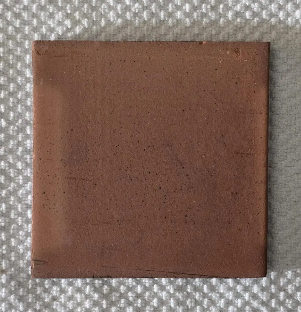 Brown textured book or album on a knitted surface.