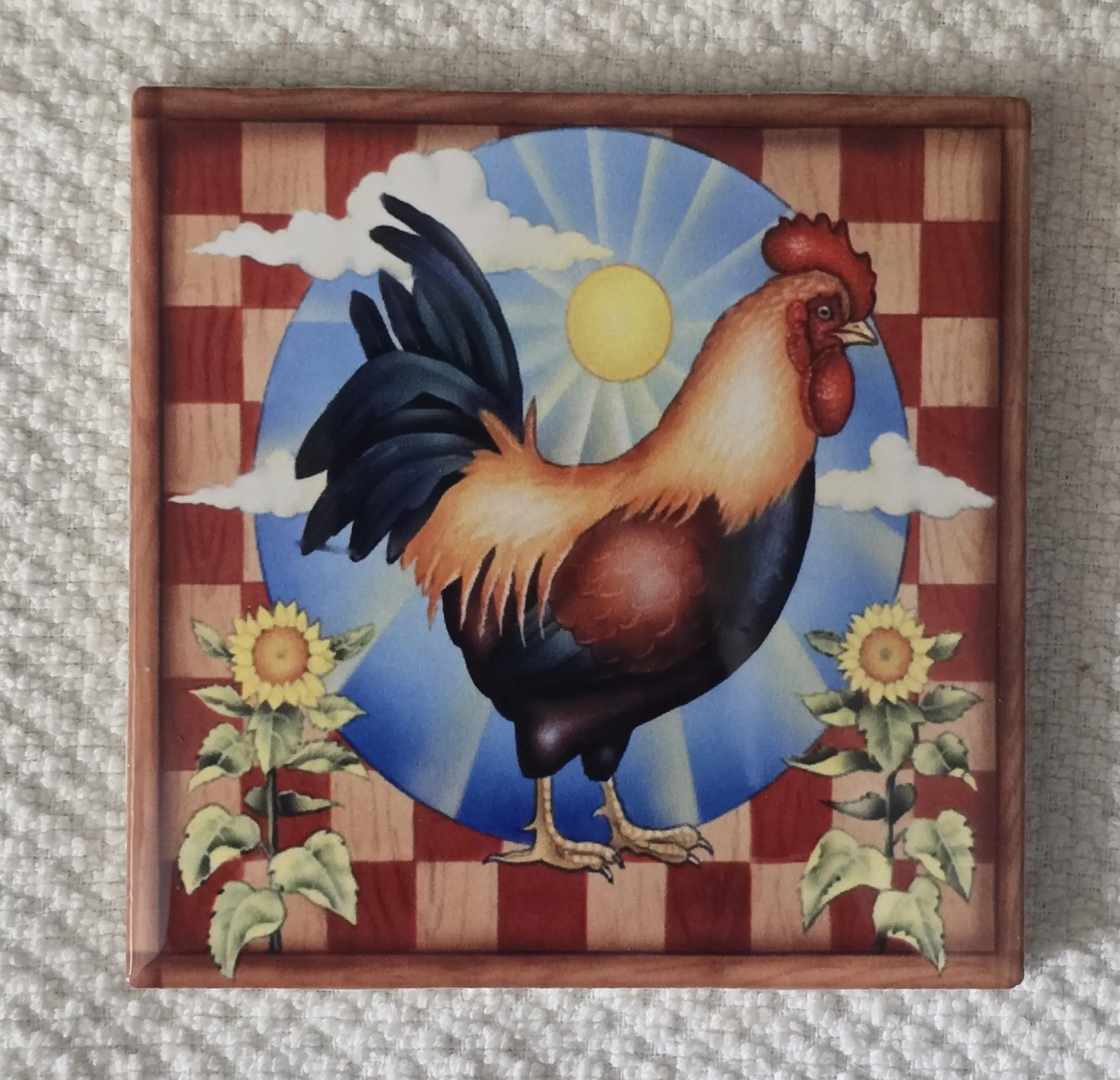 Rooster artwork with sunflowers and sun.