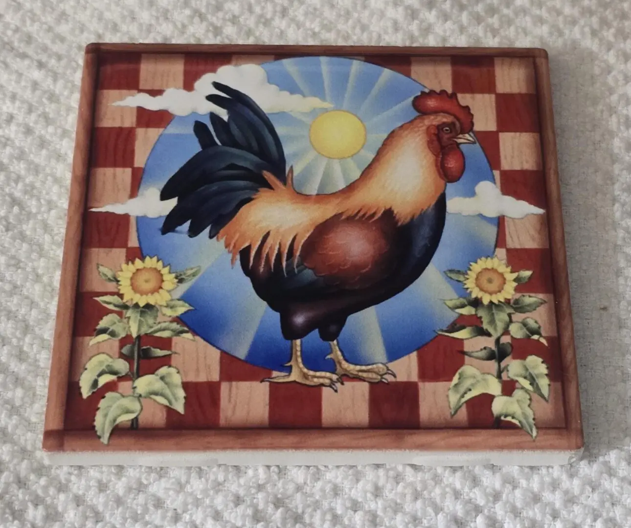 Rooster artwork with sunflowers and sun background.