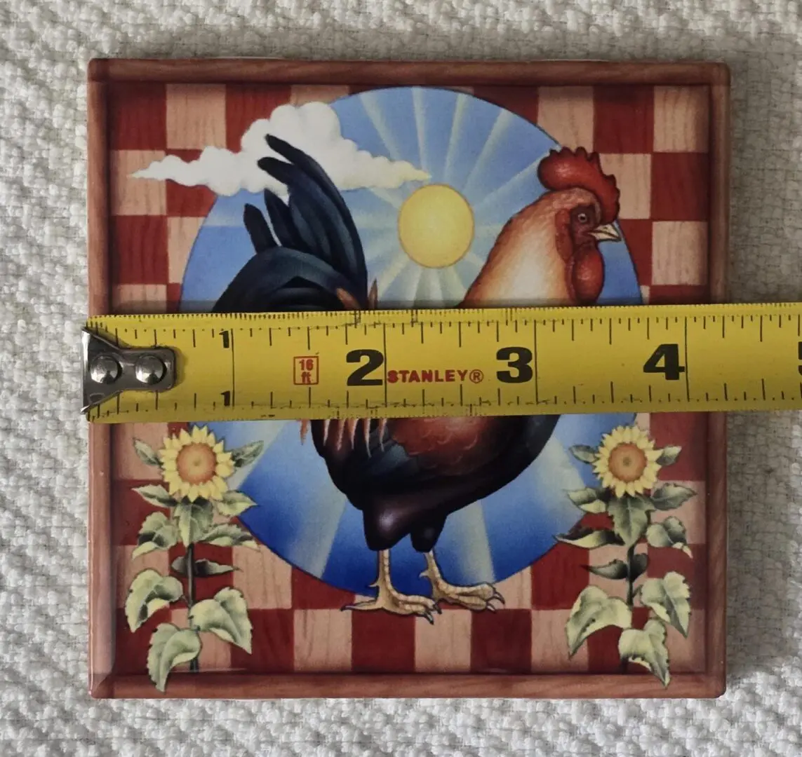 Tile with rooster and measuring tape.