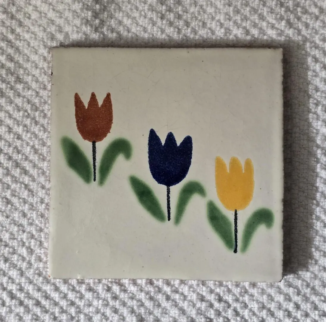 Tile with red, blue, yellow tulip design.