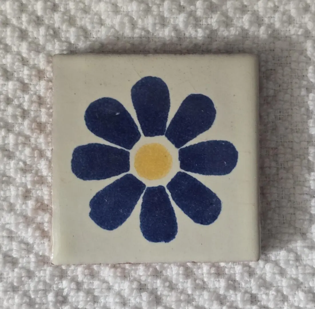 Blue flower design on ceramic tile.