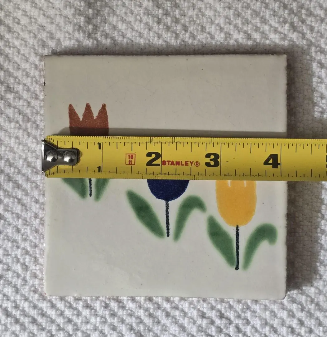 Ceramic tile with tulips and tape measure