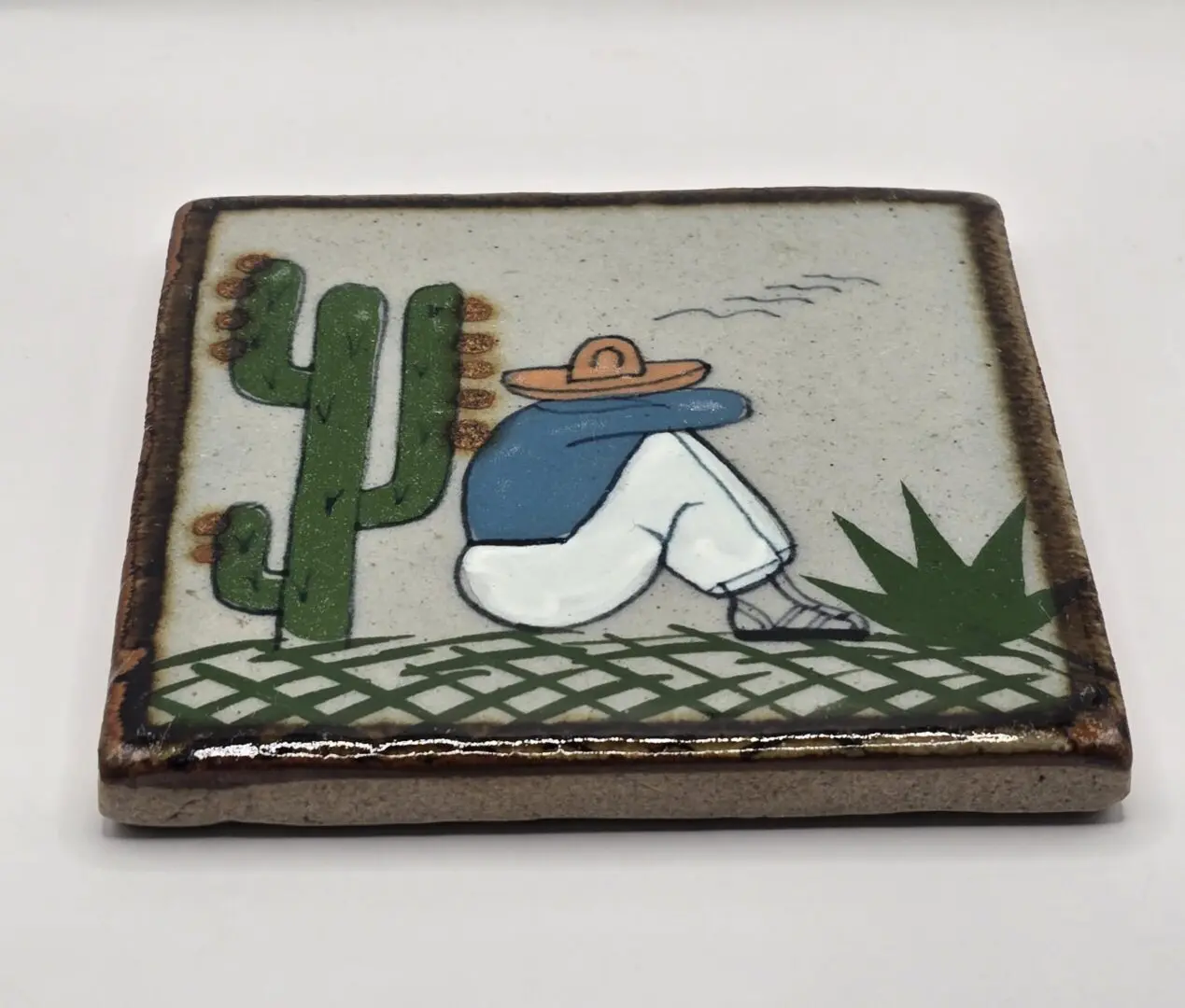 Mexican ceramic tile with seated figure