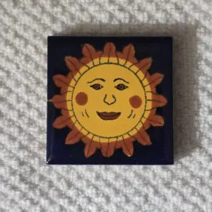 Sun face tile with smiling expression.