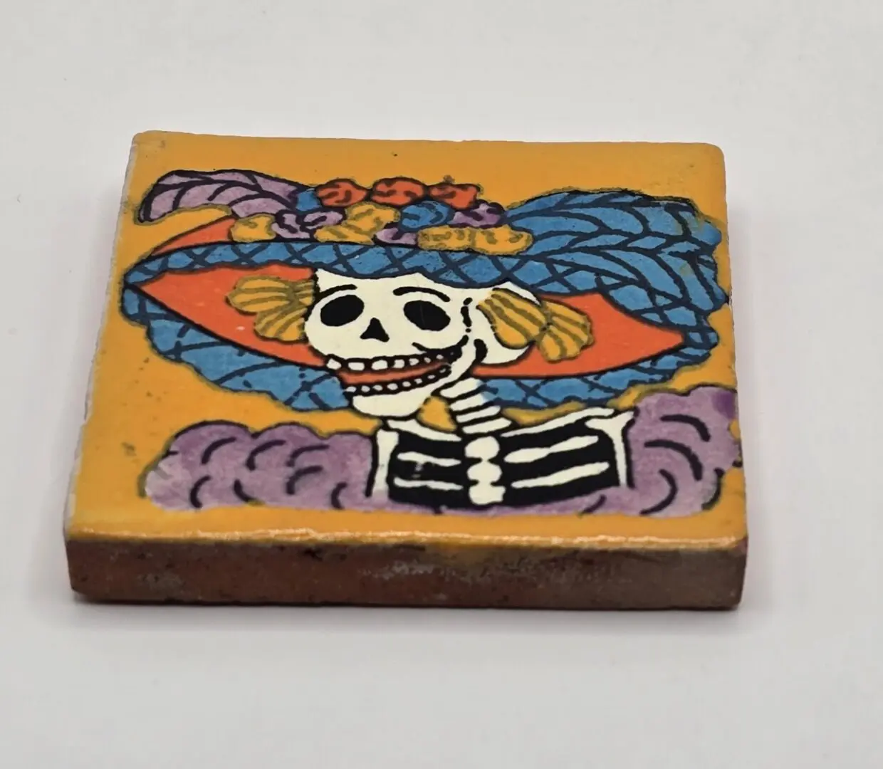 Colorful tile with skeleton in hat.