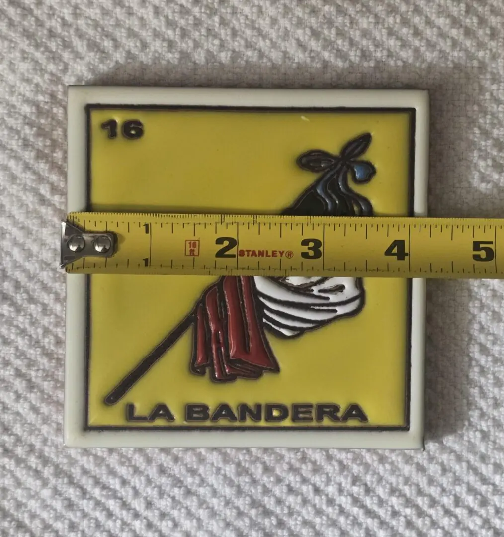 Tile with flag design and measuring tape.