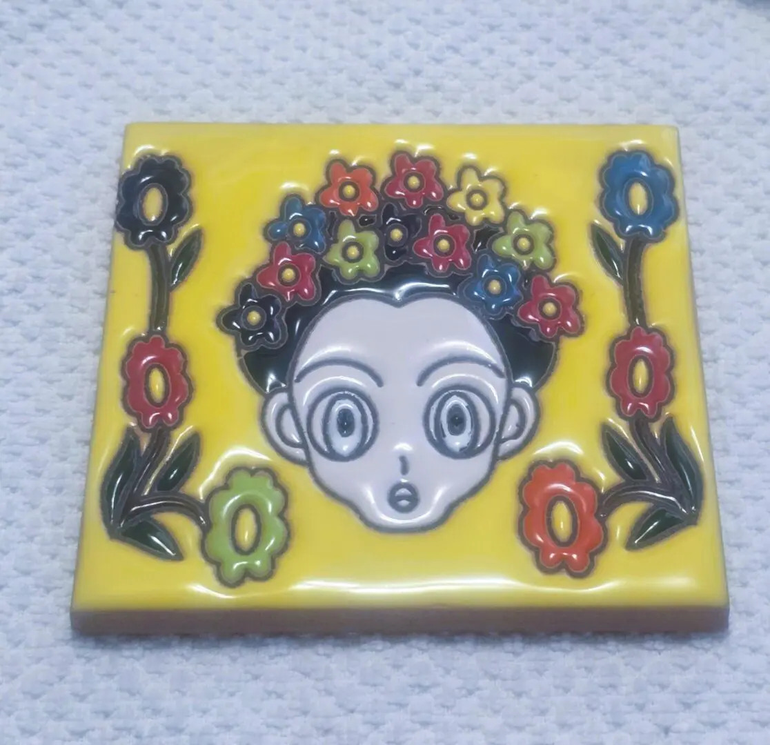 Colorful cartoon face with floral headpiece.