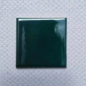 Green ceramic tile on textured background.