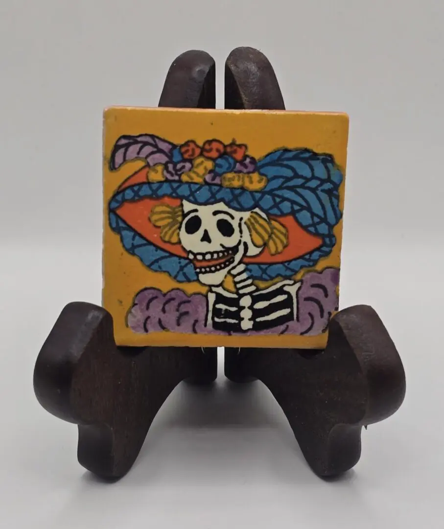 Colorful skull art on wooden stand.