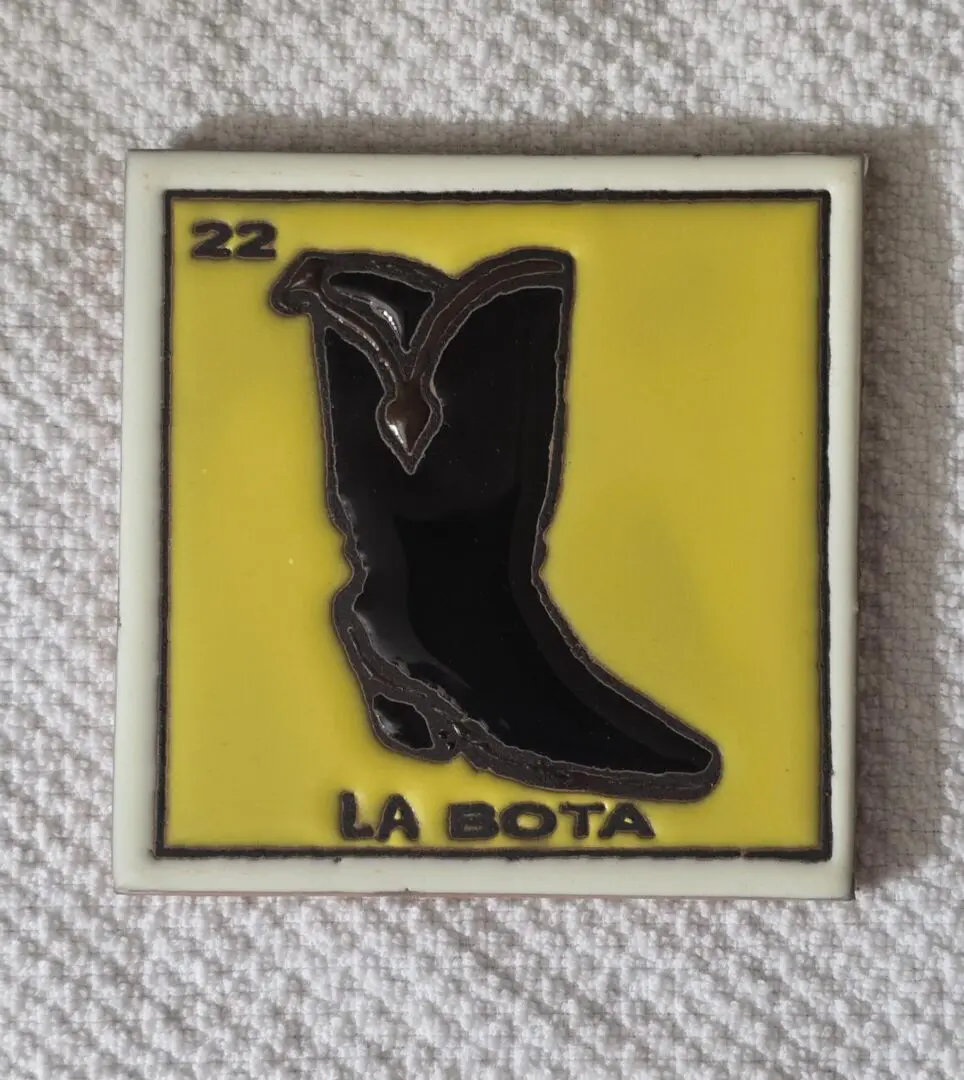 Yellow tile with black cowboy boot image.