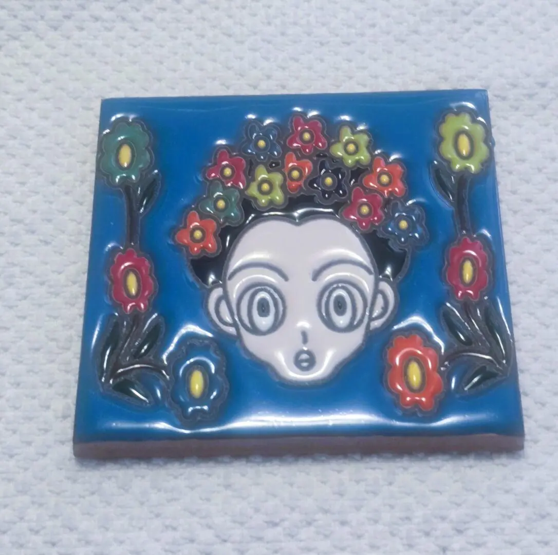 Colorful cartoon face with flower crown.