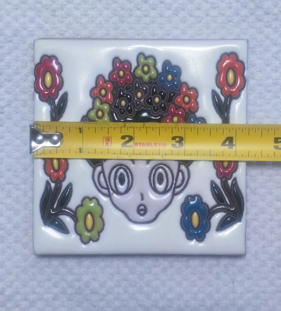 Decorative tile with ruler for measurement.