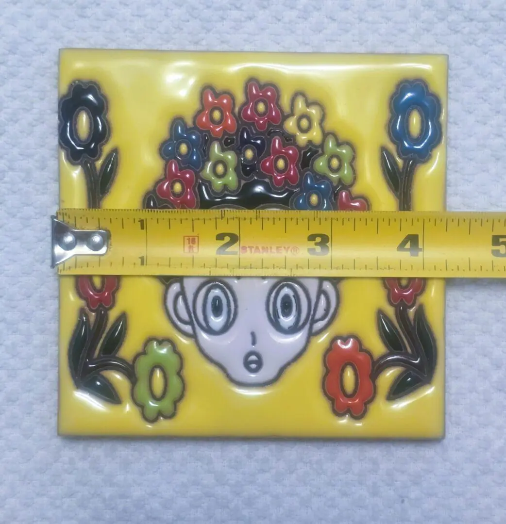 Cartoon face with flowers and measuring tape.