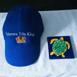 Blue cap with 'Tavera The King' and a small turtle artwork.