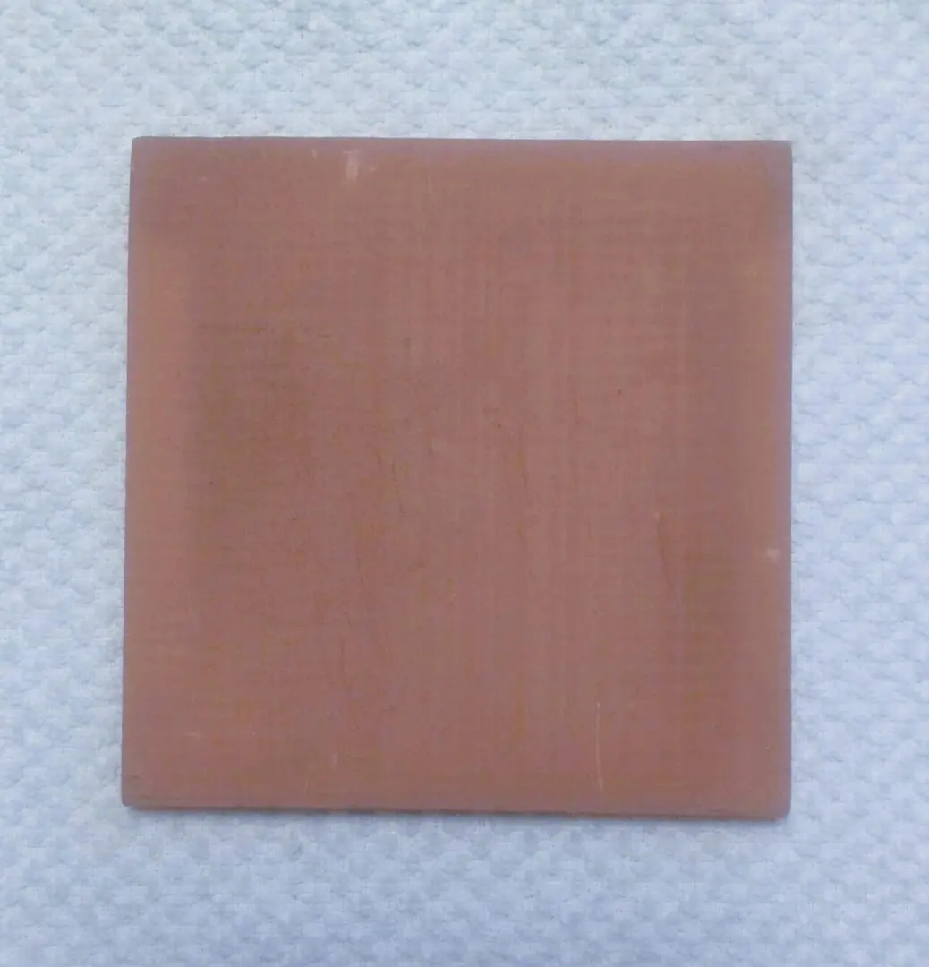 Plain brown square tile on white textured background