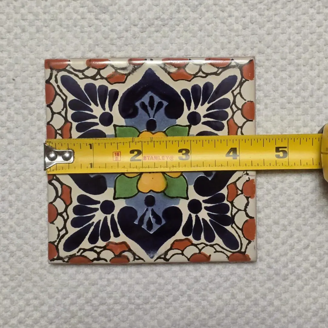 Colorful floral ceramic tile with measuring tape