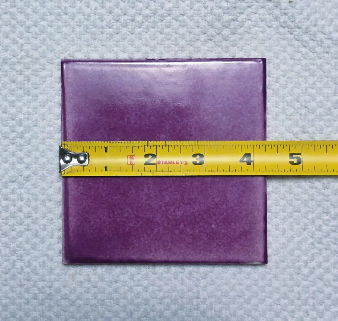 Purple tile with yellow measuring tape.