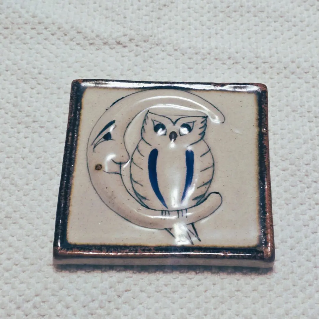 Ceramic tile featuring owl perched on moon