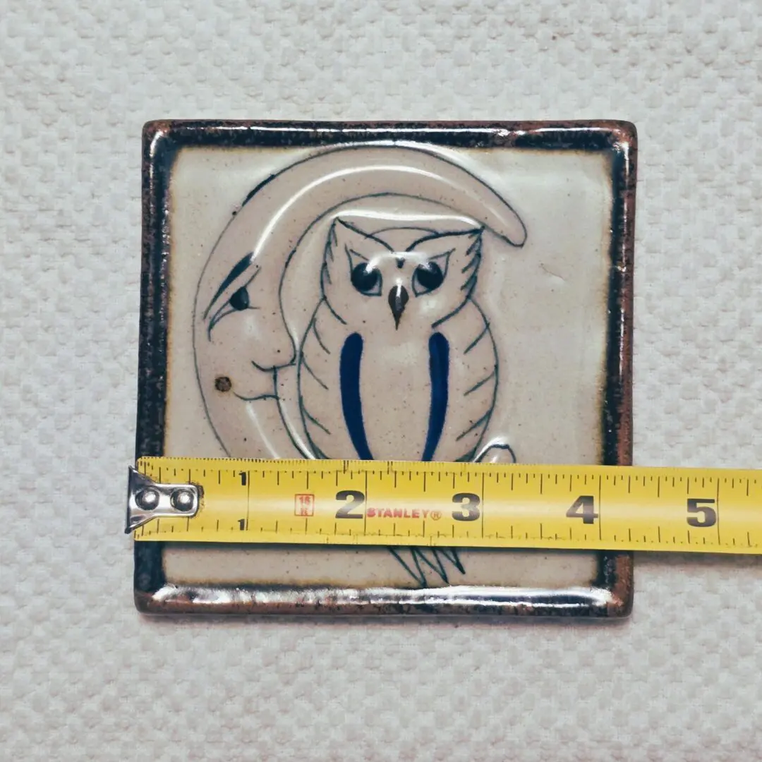 Ceramic owl tile with measuring tape