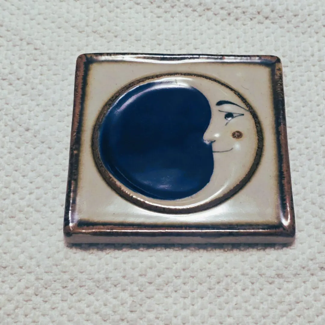 Ceramic tile with a face design.