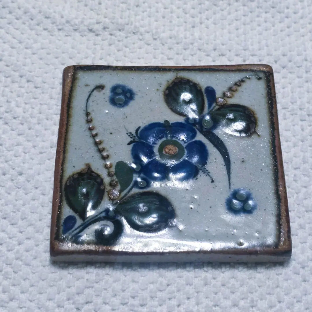 Square hand-painted ceramic tile with blue flowers