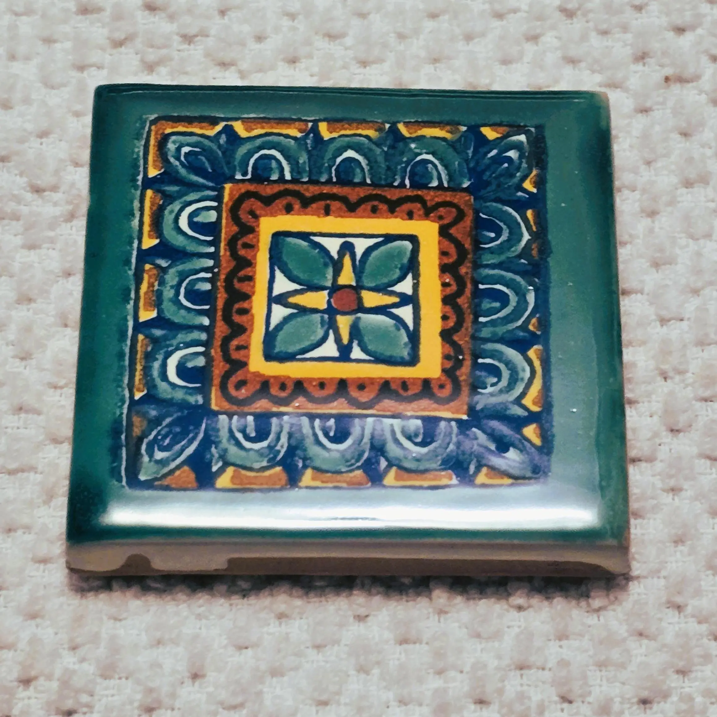 Colorful decorative tile with geometric design.
