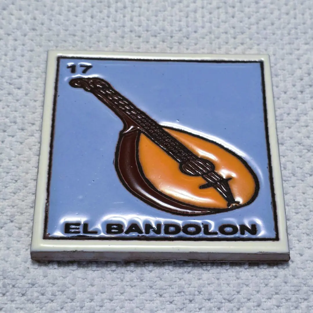 Tile with bandolon image and text.