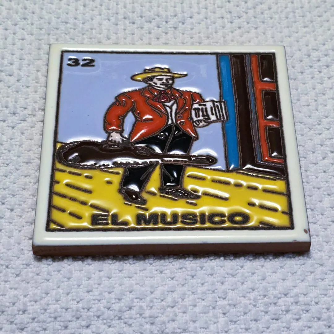 Tile art featuring musician with guitar case.
