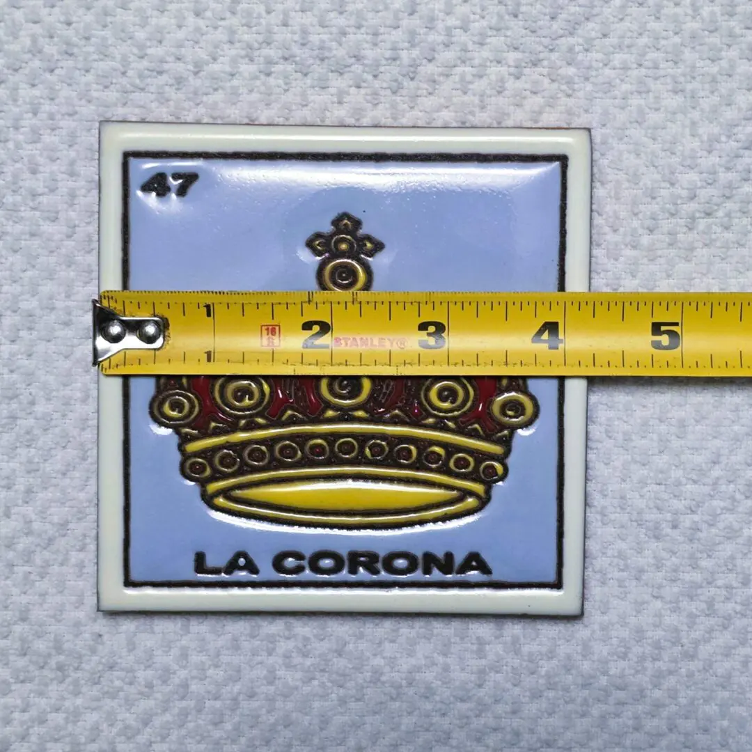 Tile with crown design and measuring tape.